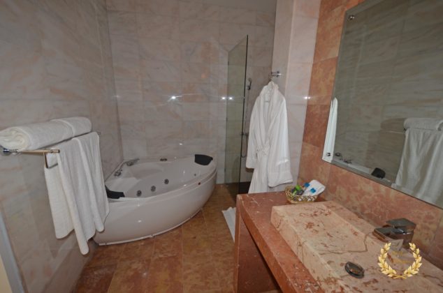 the main suite bathroom with marble and jacuzzi